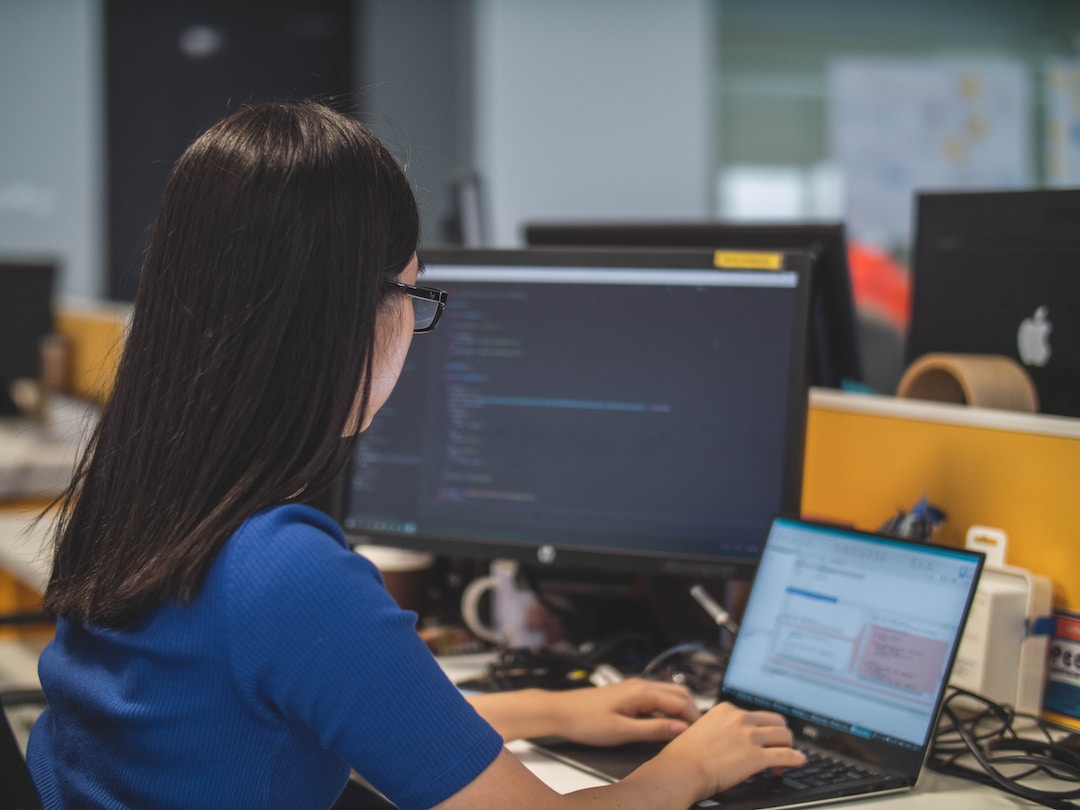 A woman in an office researching PSA software on her computer