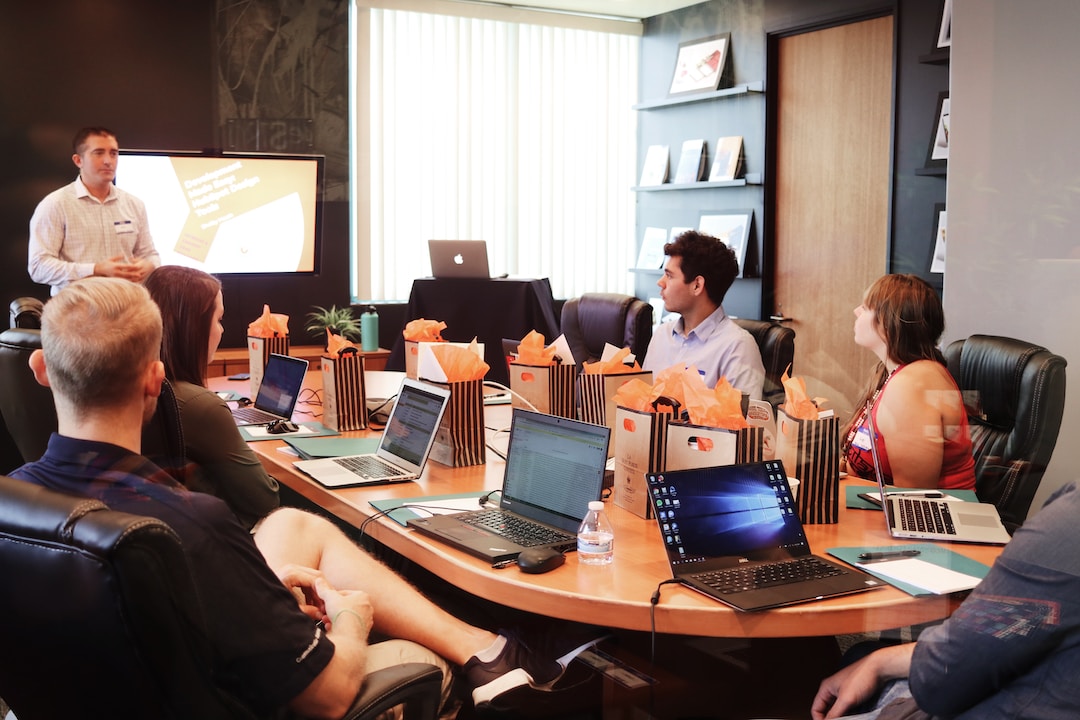 A team in an office discussing PSA software during a meeting